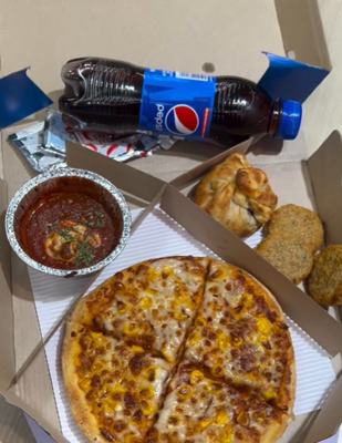 domino's outlet serving 4 course meal (corn pizza) with choco bomb